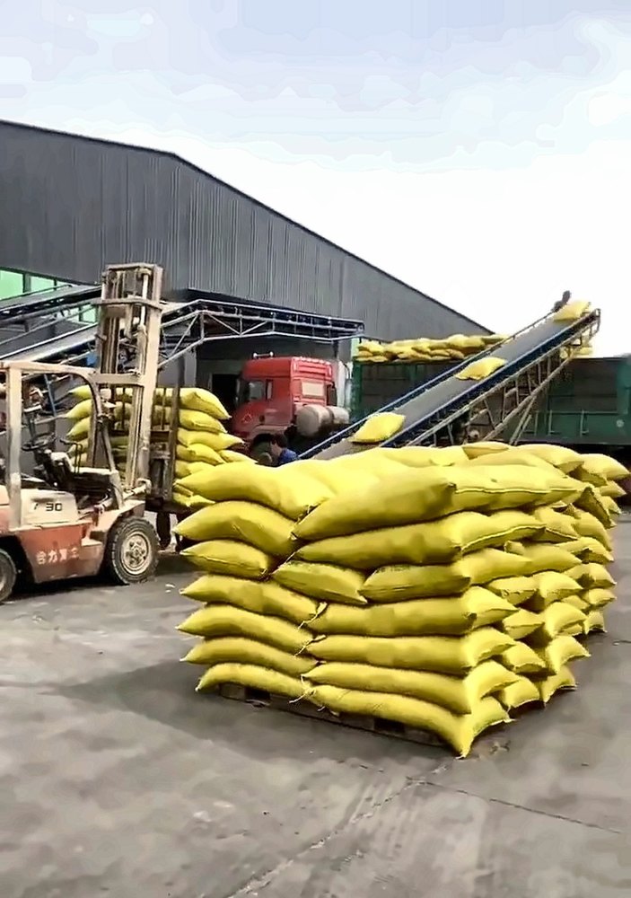 Woven bags stacked in rows inside the warehouse